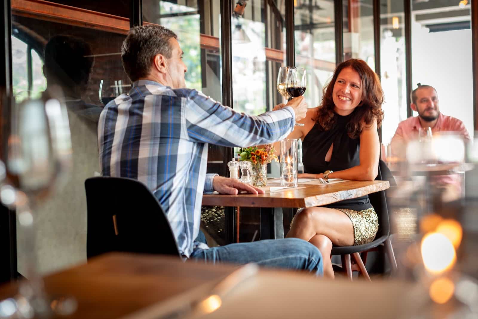 A couple enjoying a toast with wine at one of the best Wausau restaurants.