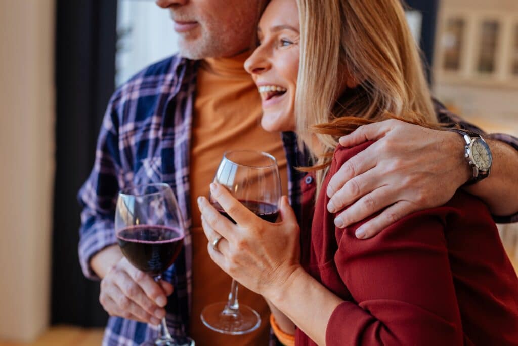 There are so many things to do during one of the best romantic getaways in Wisconsin. This couple is enjoying a glass of red wine at a winery.