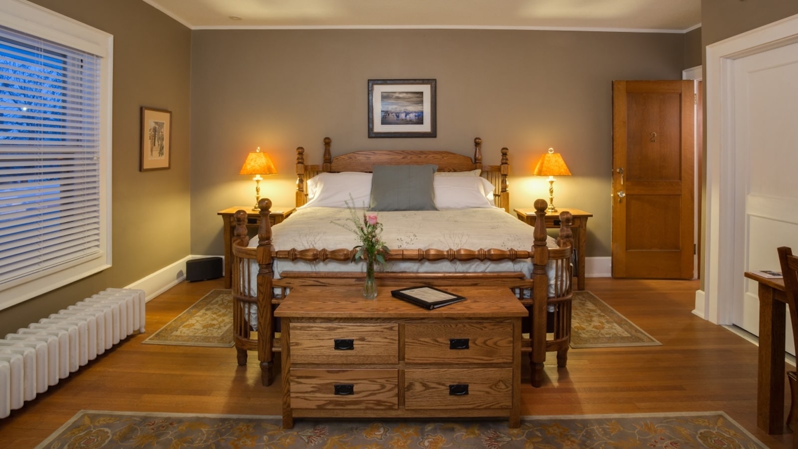 Stay at one of the most Unique Hotels in Wisconsin and enjoy a cozy room like this one with a kind bed and antique furnishings. 