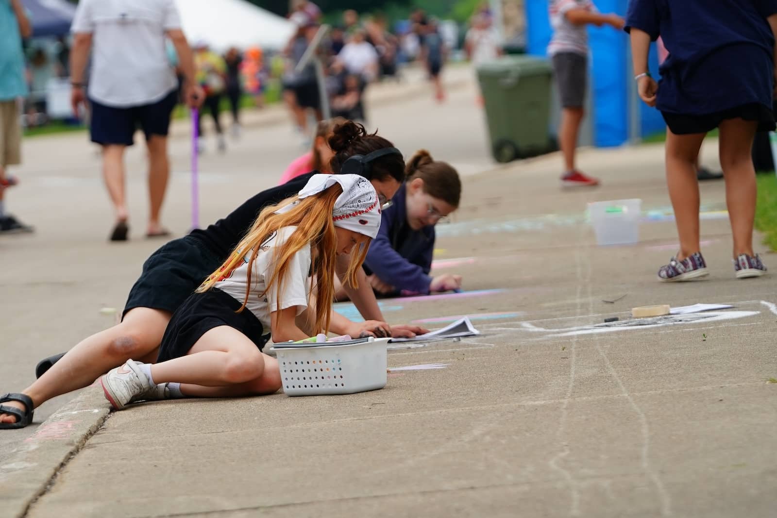Wausau Events to Look Forward to This Summer 1 Girls working on a chalk drawing on the sidewalk at Chalkfest, one of the popular Wausau events.