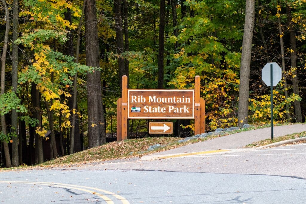 Rib Mountain State Park sign pointing to Park Road headed for Granite Peak ski area in Wausau, Wisconsin.