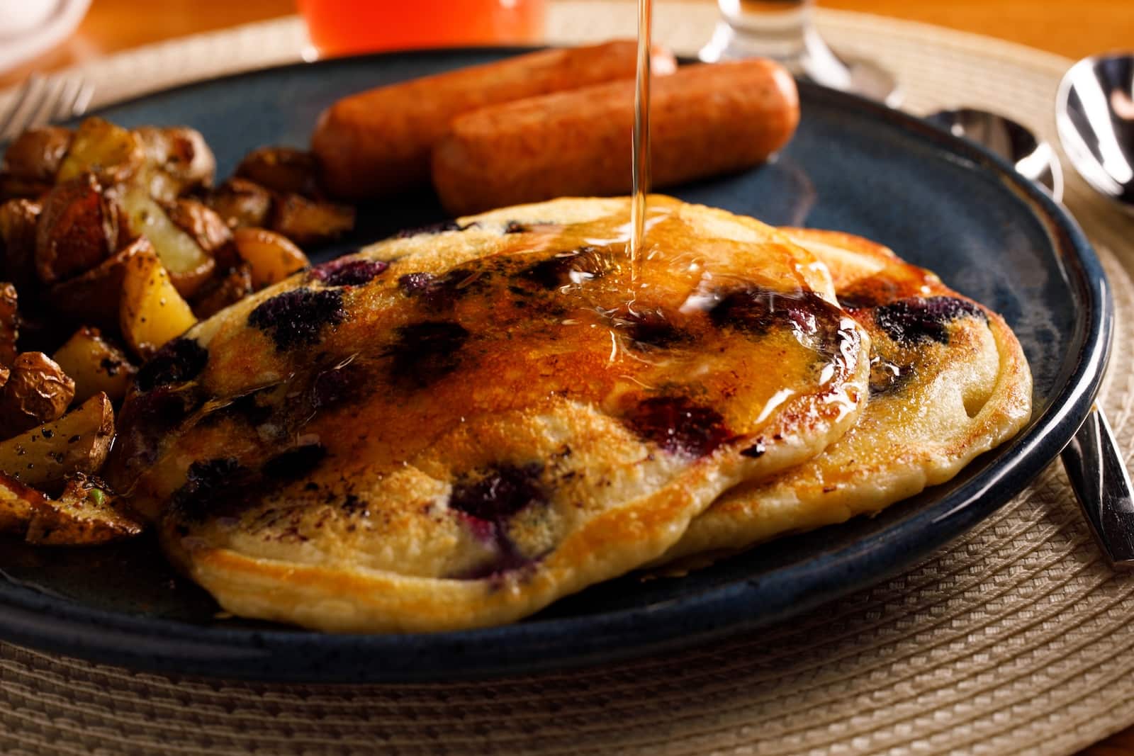 Mountain Bay State Trail: A Guide to Wisconsin's Longest Rail Trail 2 Blueberry pancakes with maple syrup and a side of sausage served at one of the best Wausau hotels.