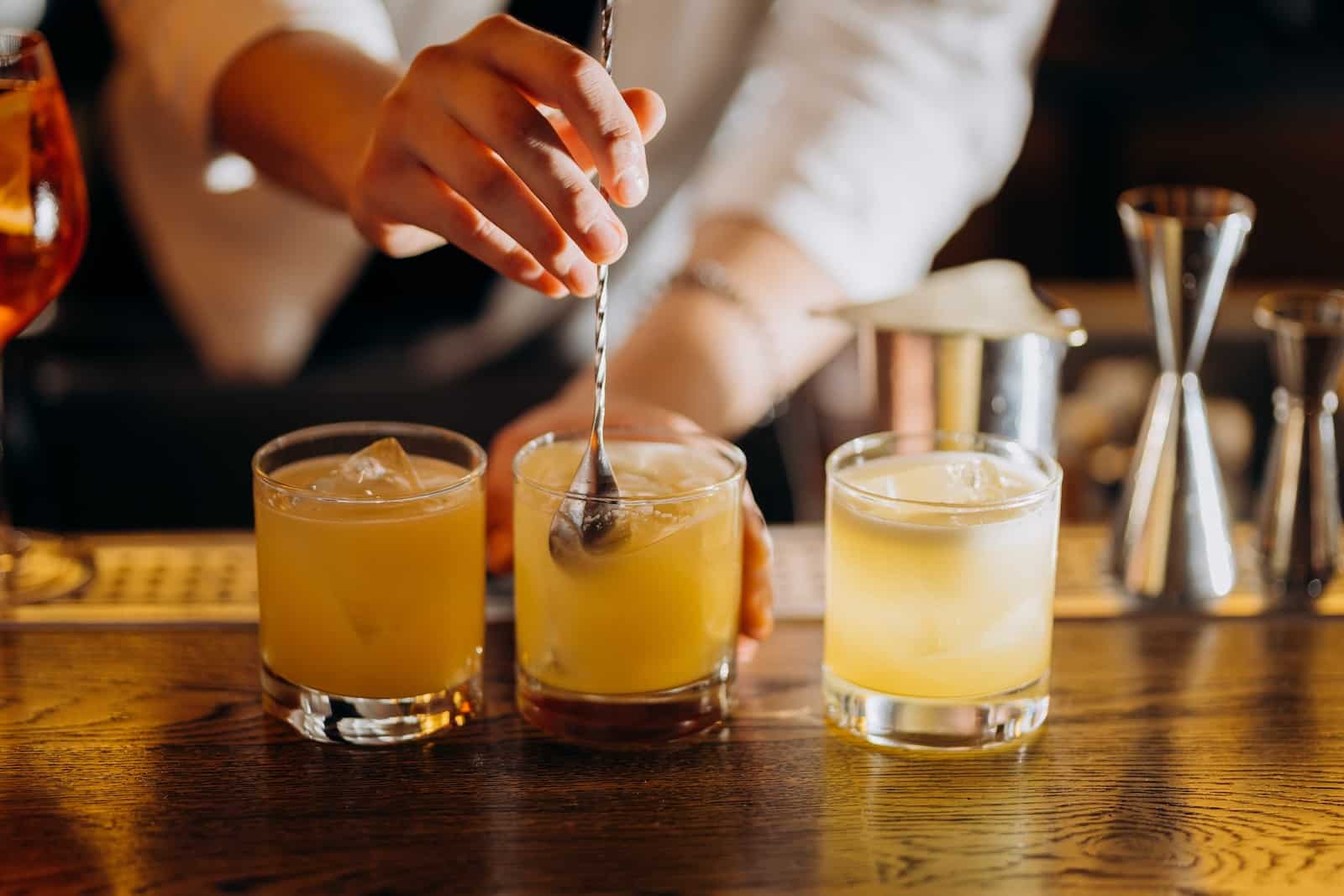 Inside the Timekeeper Distillery: Wausau's Craft Spirits Scene 1 Bartender stirring craft cocktails at Timekeeper Distillery in Wausau WI.